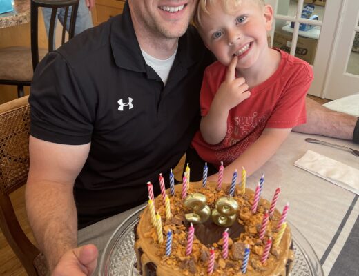 dad and son with birthday cake